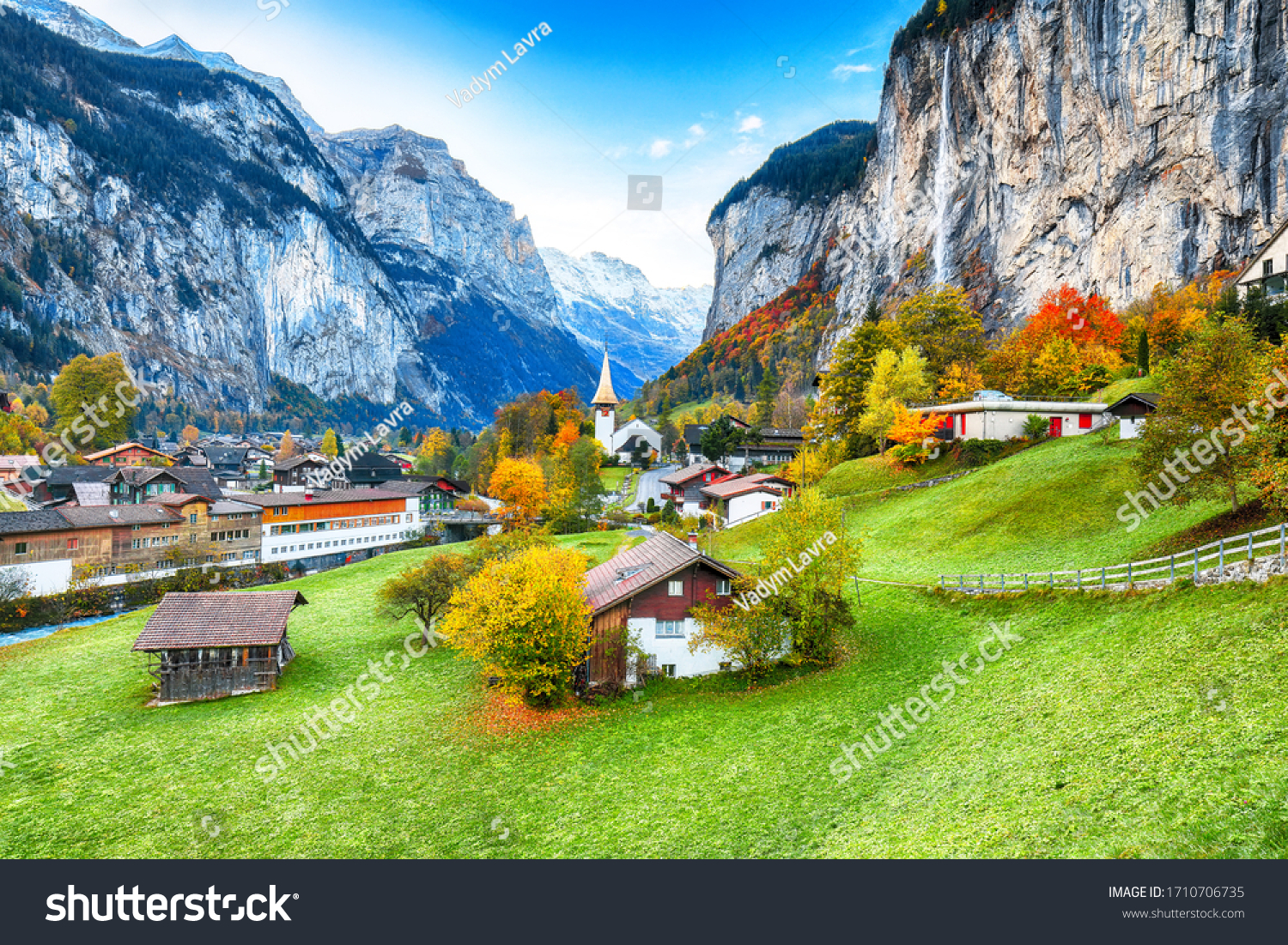 Amazing autumn landscape of touristic alpine village Lauterbrunnen with famous church and Staubbach waterfall. Location: Lauterbrunnen village, Berner Oberland, Switzerland, Europe. #1710706735