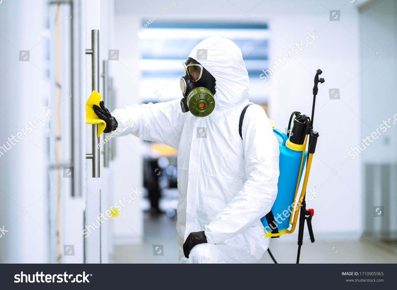 Cleaning and disinfection of office to prevent COVID-19, Man in protective hazmat suit washes office furniture to preventing the spread of coronavirus, pandemic in quarantine city. #1710905965
