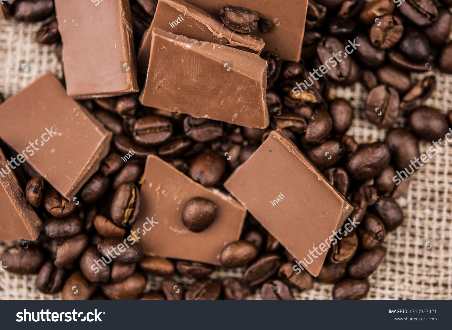Chocolate and coffee beans on a textile background #1710927421