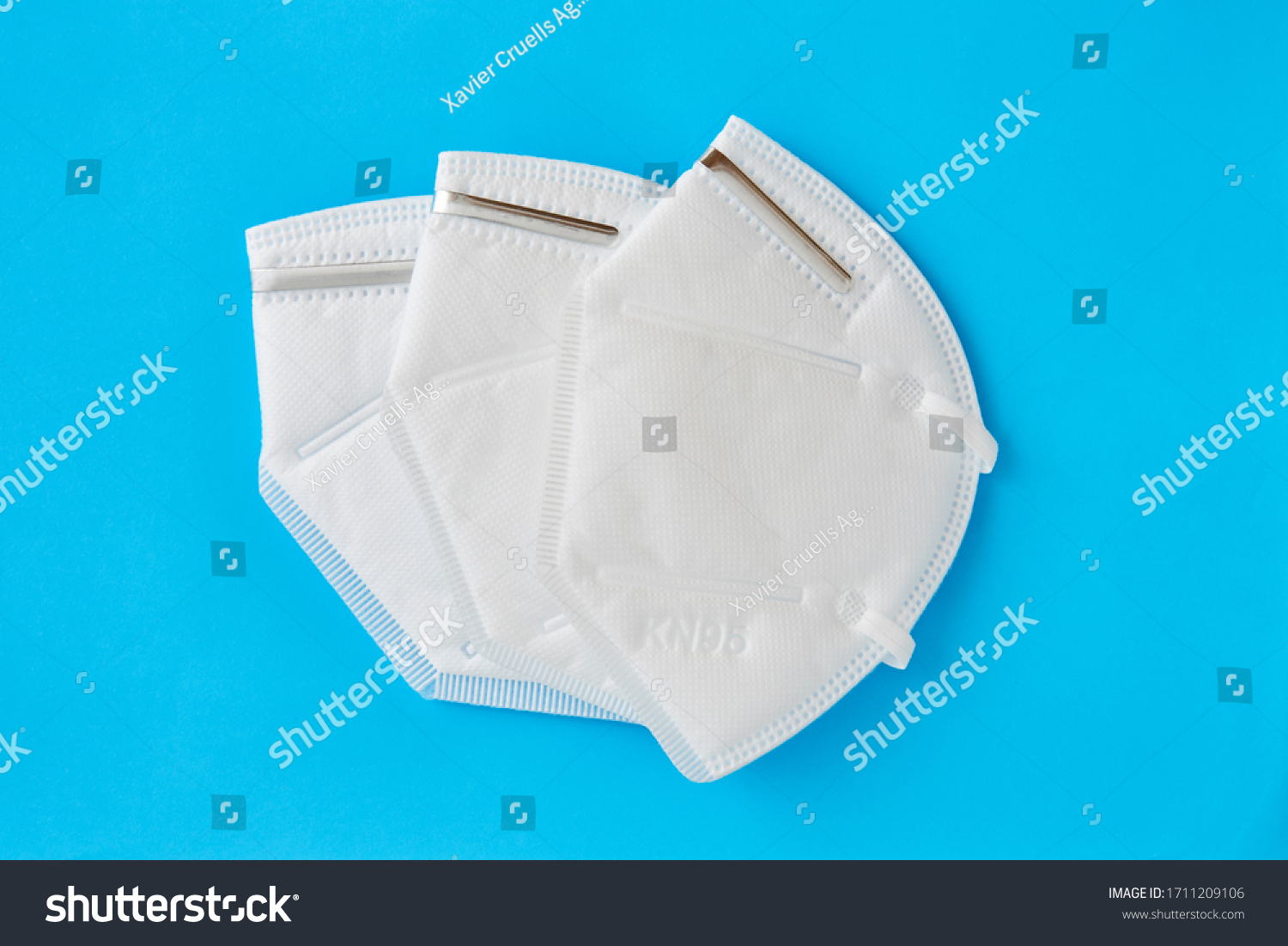 Set of three KN95 FPP2 disposable medical respirator white mask medical equipment on blue background.  #1711209106