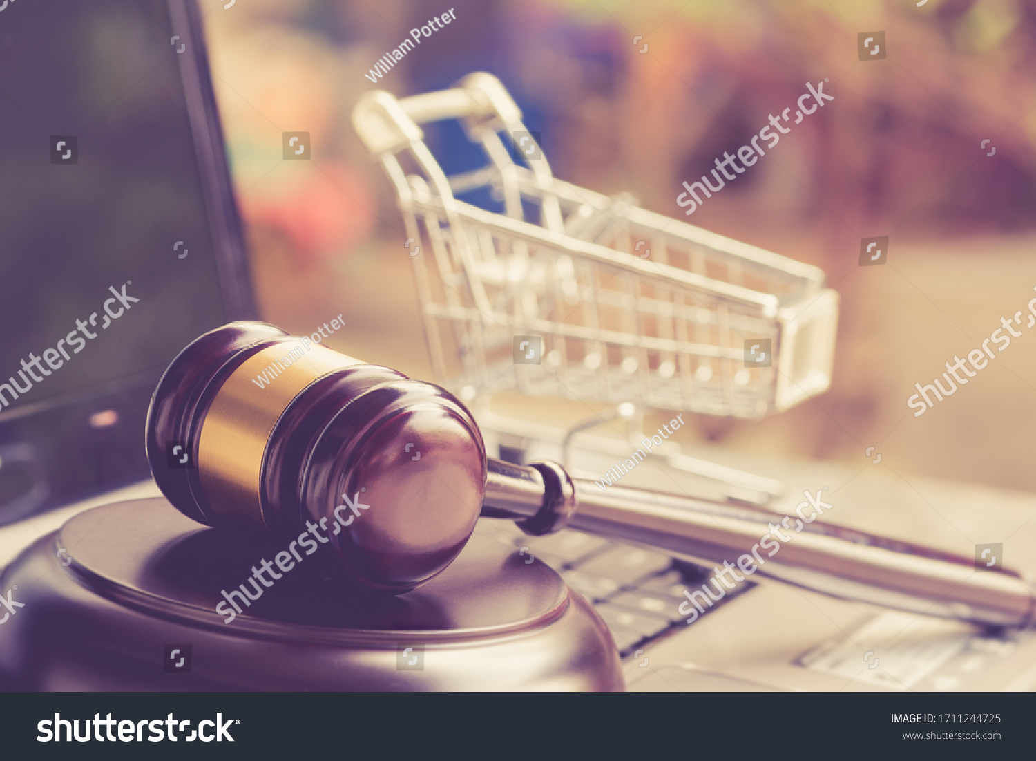 E-commerce law, rules and regulations concept : Wooden judge gavel and shopping cart on a laptop, depicts good practice vendor must do for consumer e.g provide clear data, order cancellation, refund #1711244725