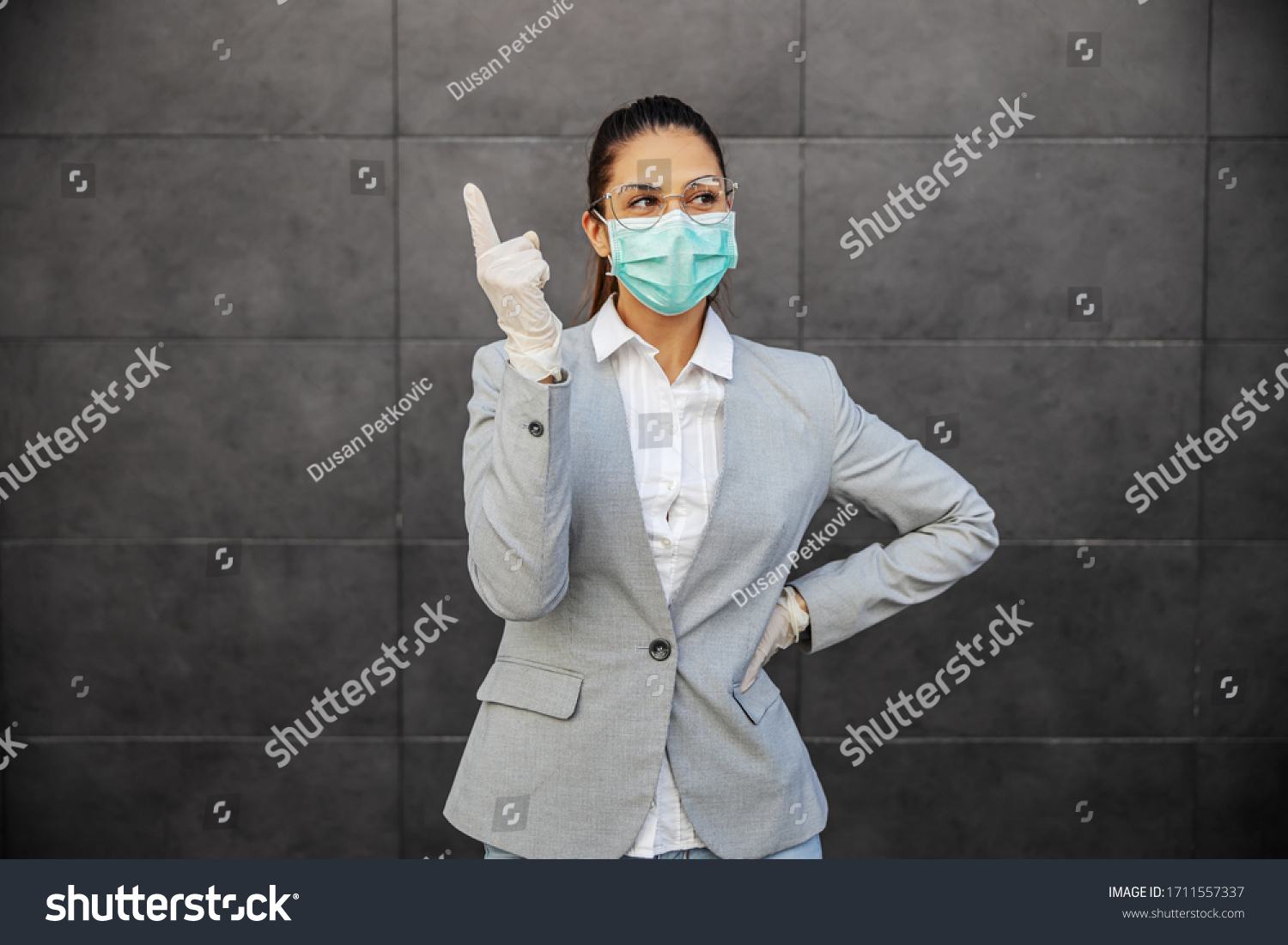 Young woman in business suit with mask and gloves, prevent infection of Covid-19 virus coronavirus,contamination of germs or bacteria. Infection prevention and control of epidemic.  #1711557337