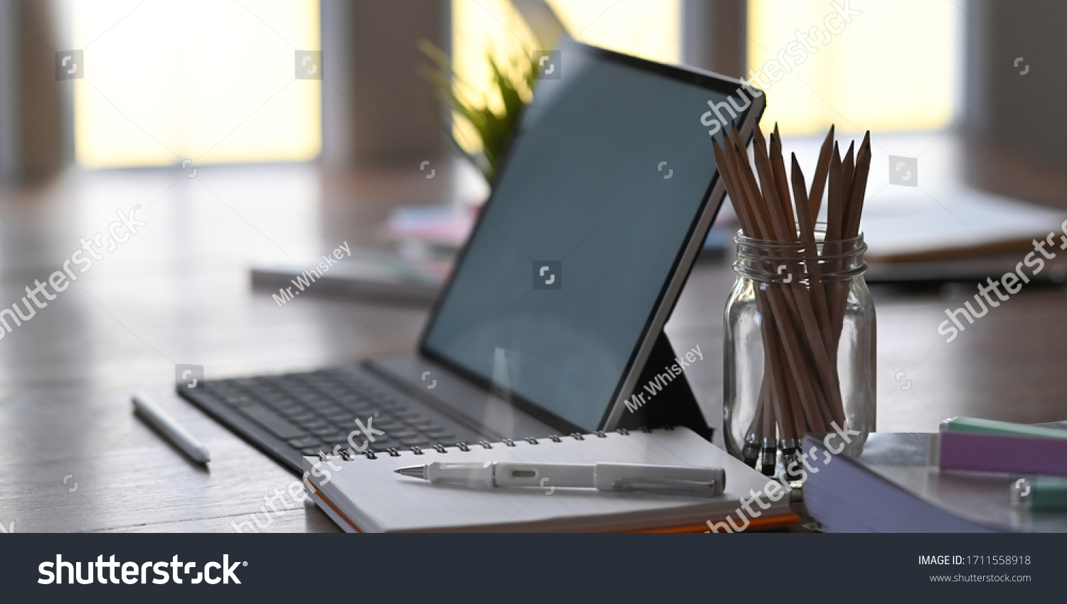 Office equipment on home working desk with tablet, pencil, pen and notebook. #1711558918