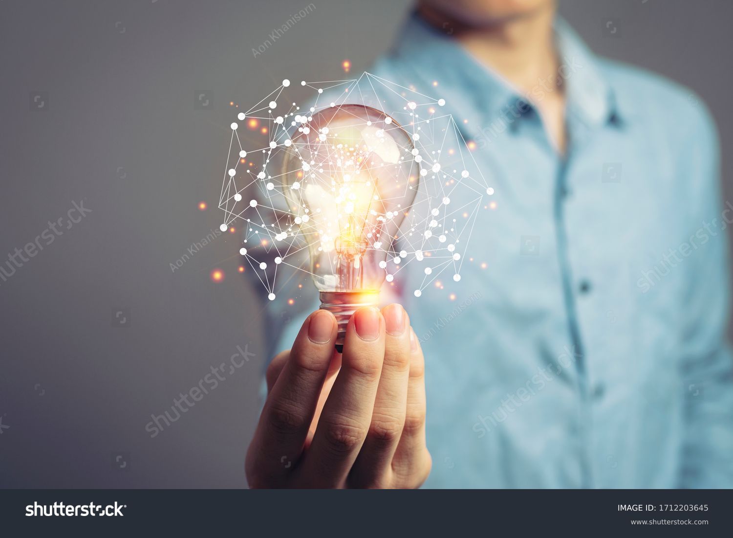 Man holding light bulbs, ideas of new ideas with innovative technology and creativity. concept creativity with bulbs that shine glitter. #1712203645