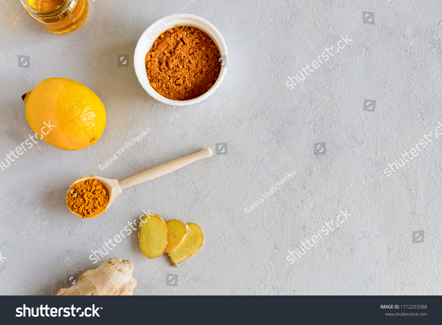 On a white background is a set of products for making drinks to support the immune system and prevent diseases lemon, turmeric, honey, ginger.Herbal medicine an anti-inflammatory. Copy space, flat lay #1712253388