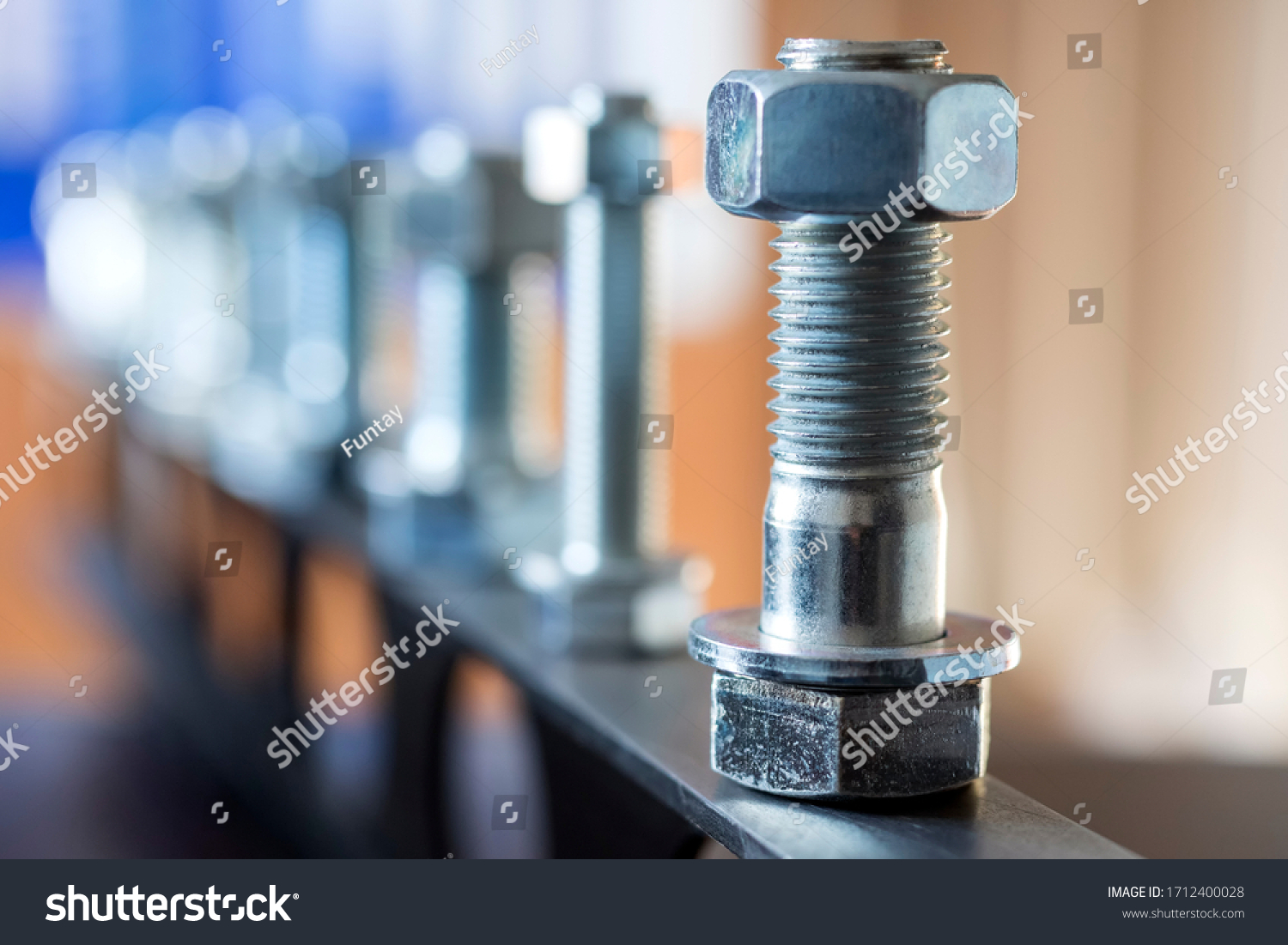 View of the bolts and nuts (fasteners). A bolt is a form of threaded fastener with an external male thread. Bolts are very closely related to screws. Bolts are often used to make a bolted joint. #1712400028