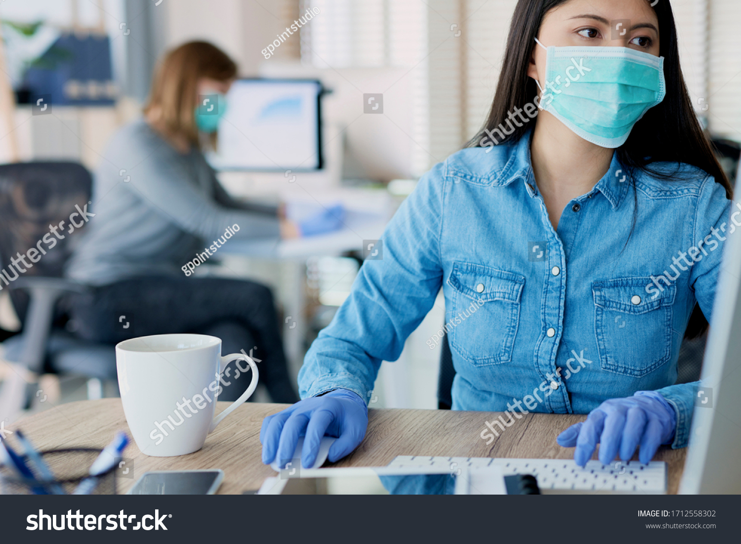 Woman in protective gloves and mask in the office #1712558302