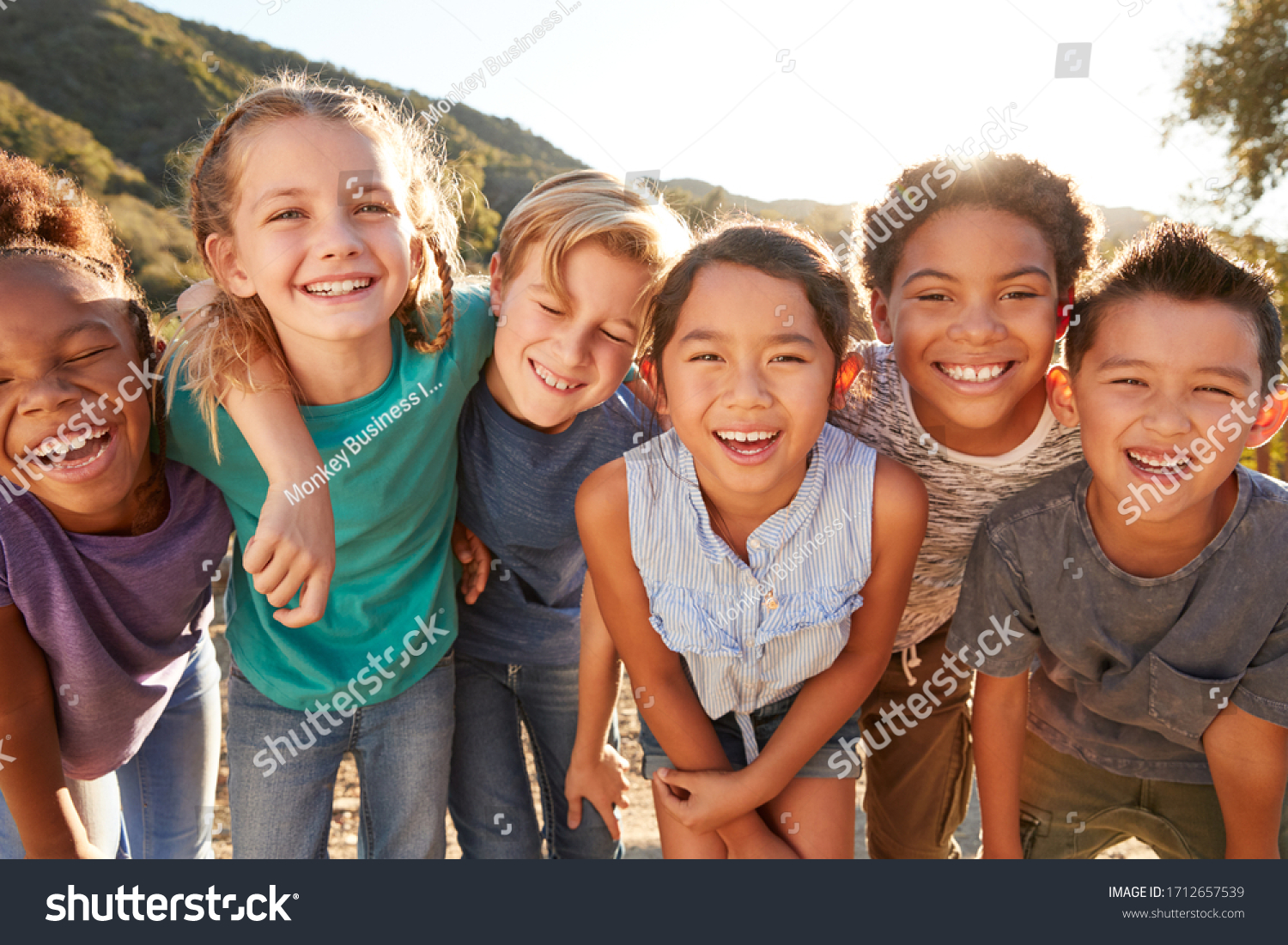 Portrait Of Multi-Cultural Children Hanging Out With Friends In The Countryside Together #1712657539