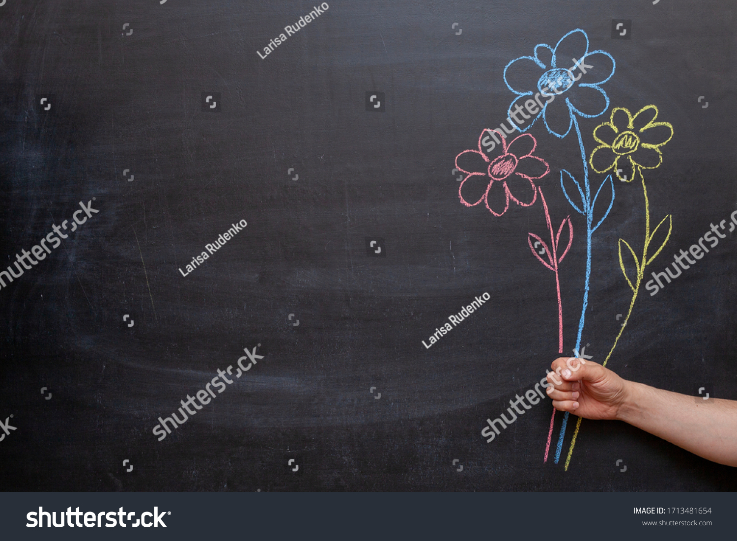 A man's hand holds flowers drawn on a chalkboard in his hand. #1713481654