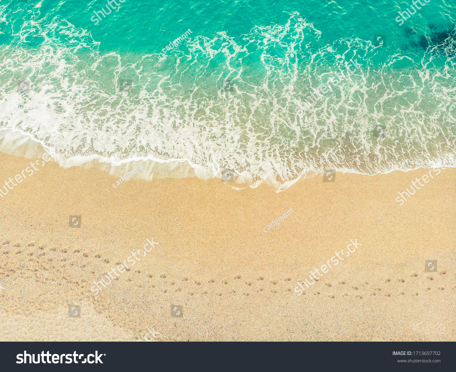 Top view of a beach with barefoot walk marks along #1713697702