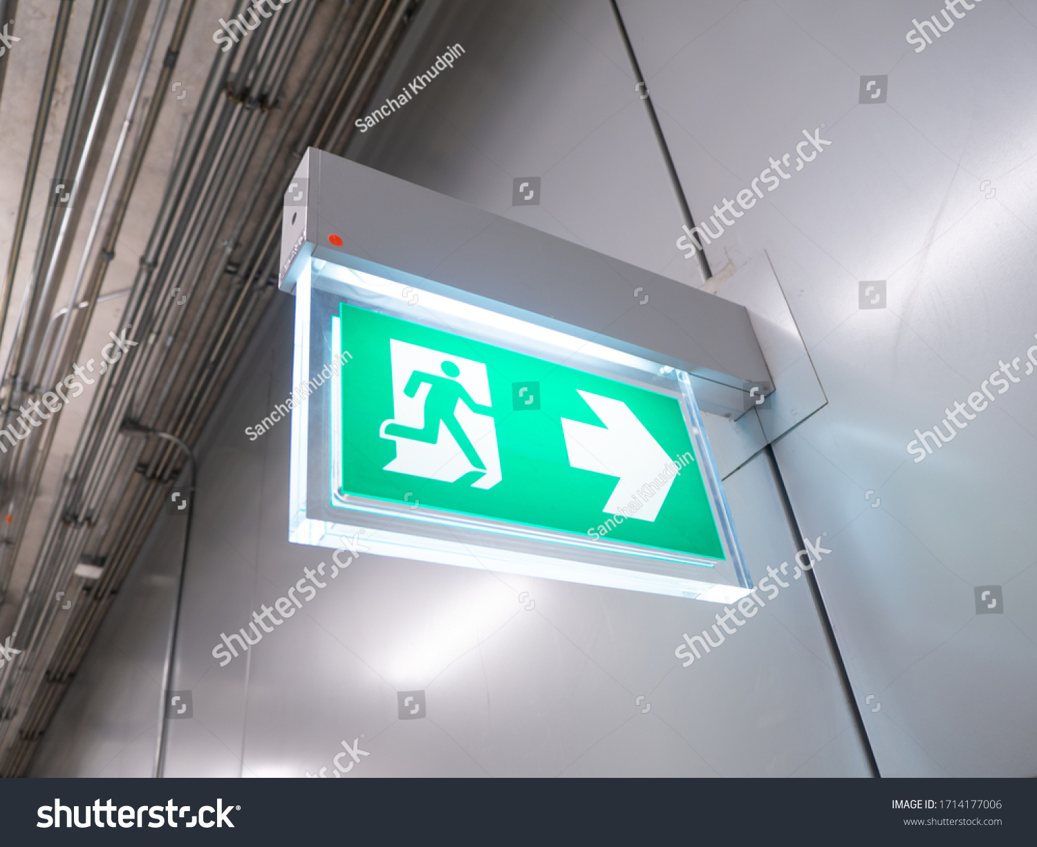 led sign in corridor point way out of resident apartment building, Fire warning exit with arrow symbol sign box light Emergency Exit #1714177006
