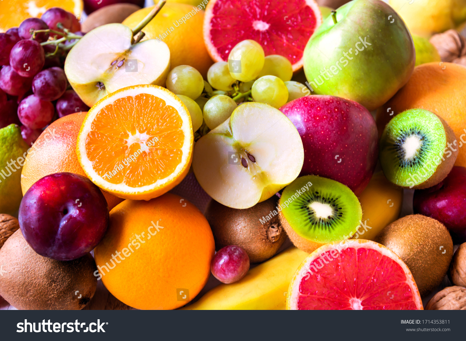 Various assorted juicy fruits: kiwi, orange, apple, grapes, grapefruit #1714353811