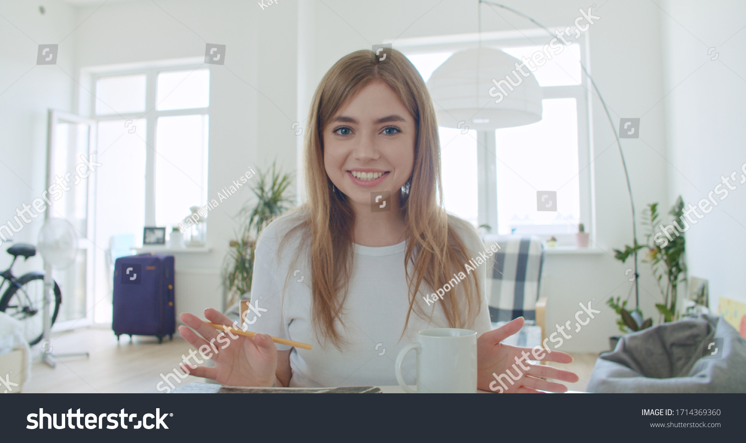 Smiling young woman blogger vlogger influencer working at home. Girl speaking looking at camera talking making videochat or conference call, Female record blog vlog #1714369360