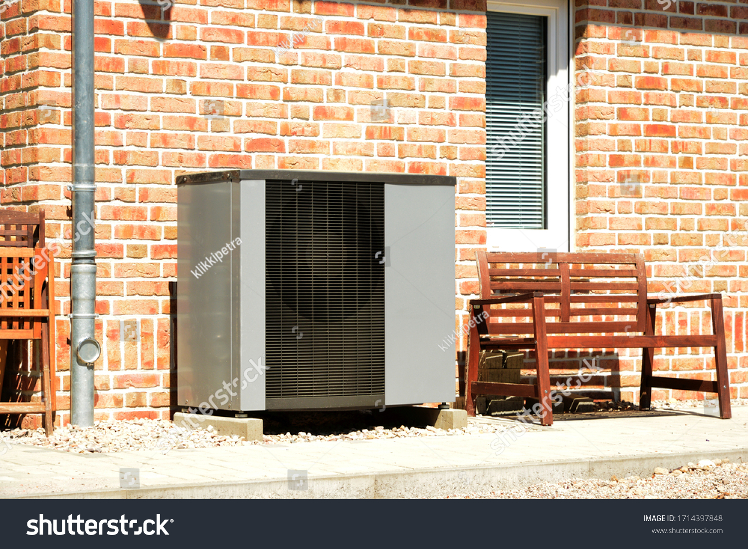 Air-Air Heat Pump for Heating and hot Water in Front of an Apartment Building #1714397848