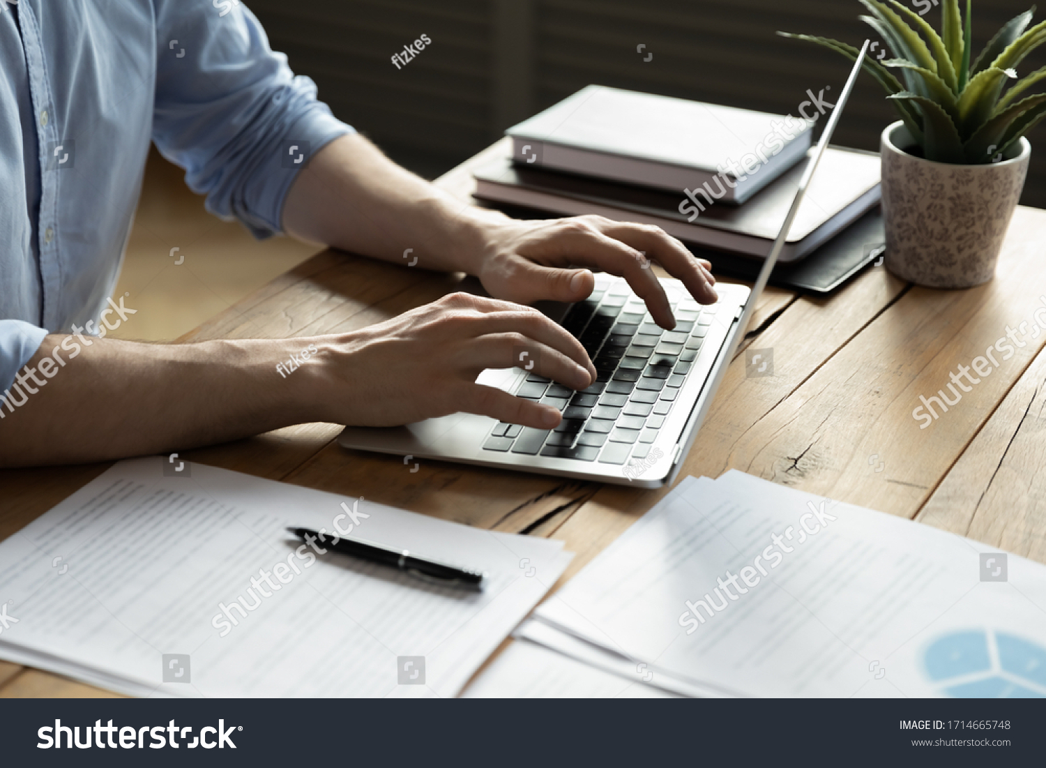 Close up businessman using laptop, typing on keyboard, sitting at wooden desk with documents, writing email, accountant writing financial report, busy student studying online, searching information #1714665748