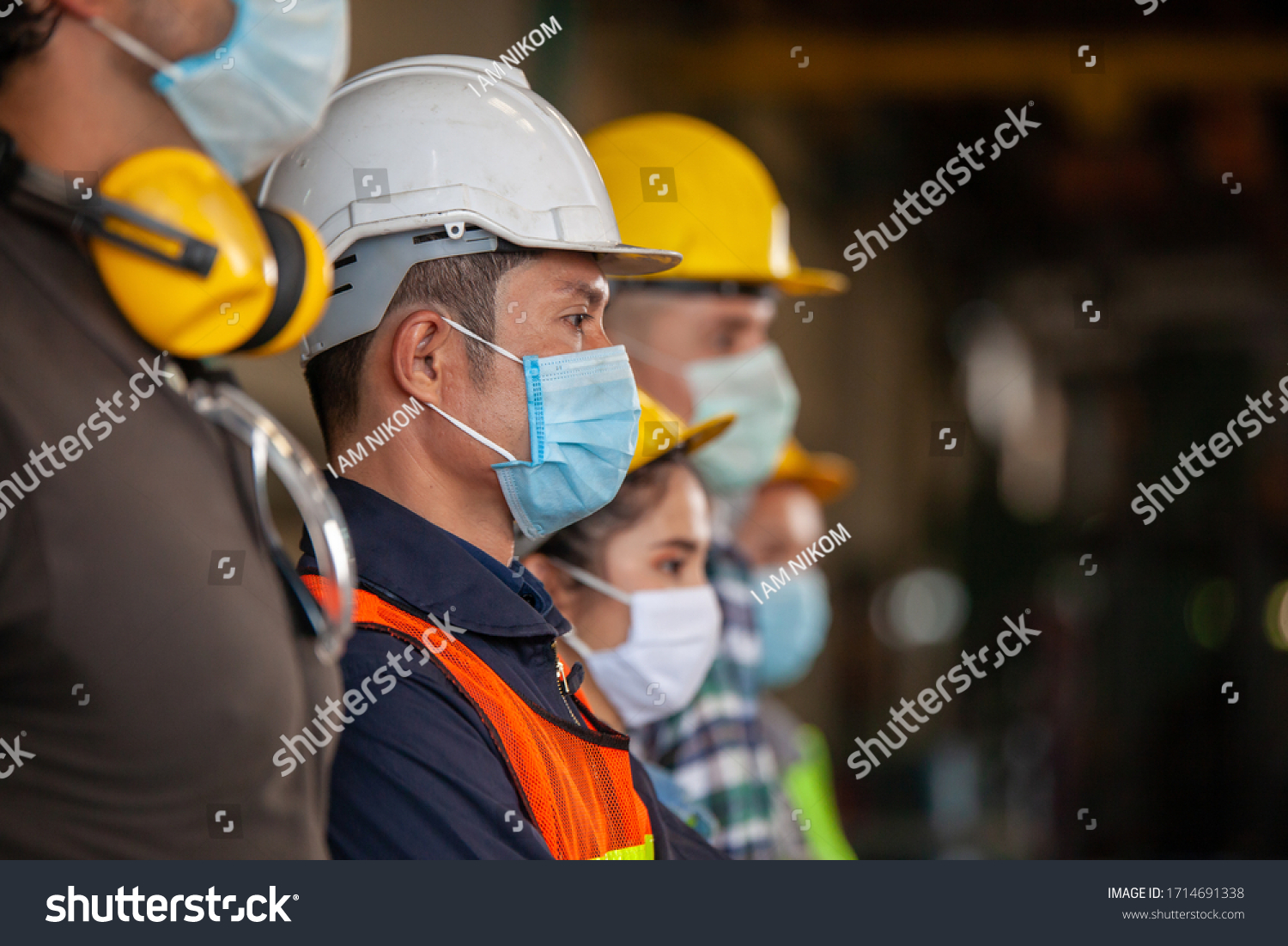 Workers wear protective face masks for safety in machine industrial factory. #1714691338