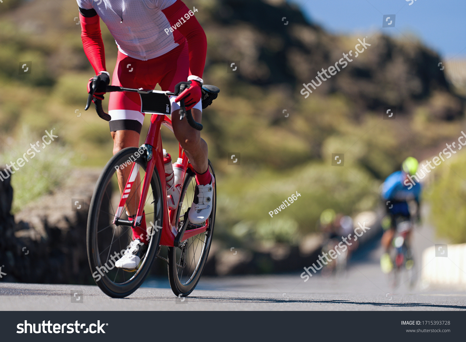 Cycling competition,cyclist athletes riding a race, climbing up a hill on a bicycle #1715393728
