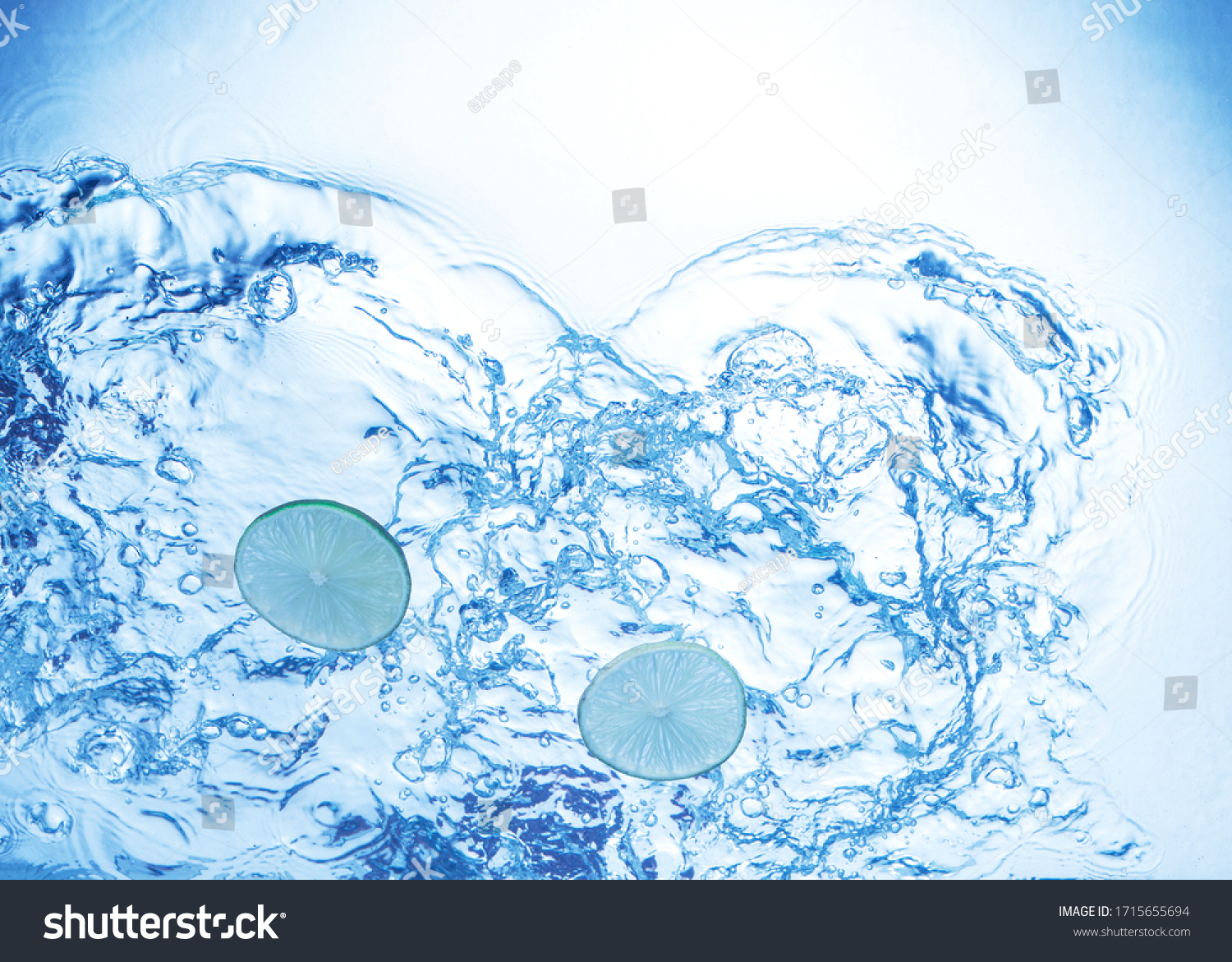 Lemon cut in water - viewed from under light blue water. #1715655694
