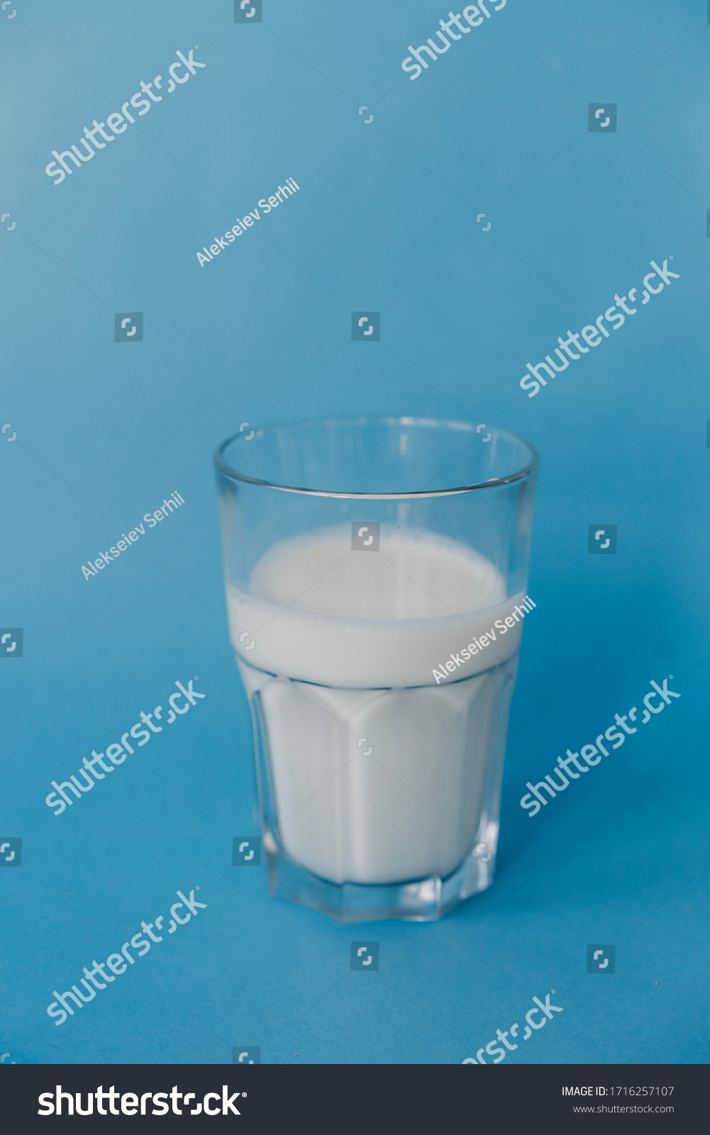 in a transparent glass with milk on a blue background
 #1716257107