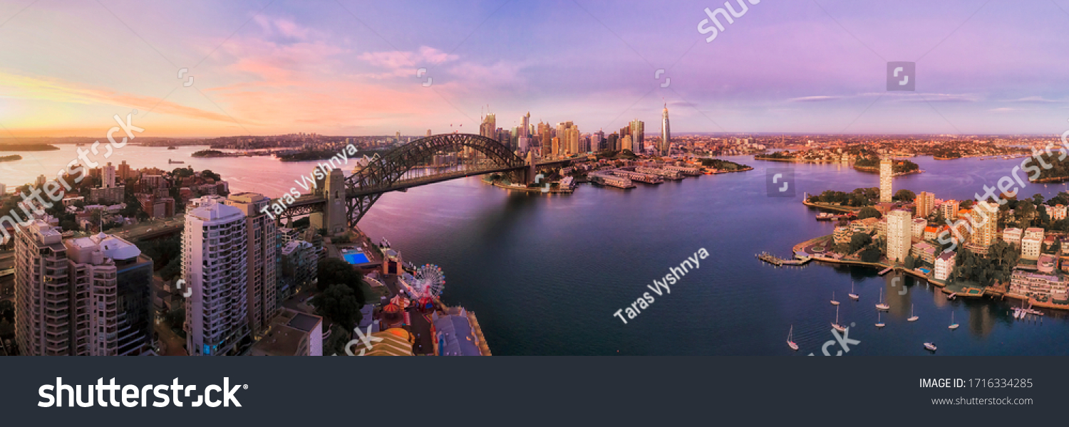 Lavender bay on Sydney Harbour in front of city CBD and major landmarks in wide aerial panorama at sunrise. #1716334285