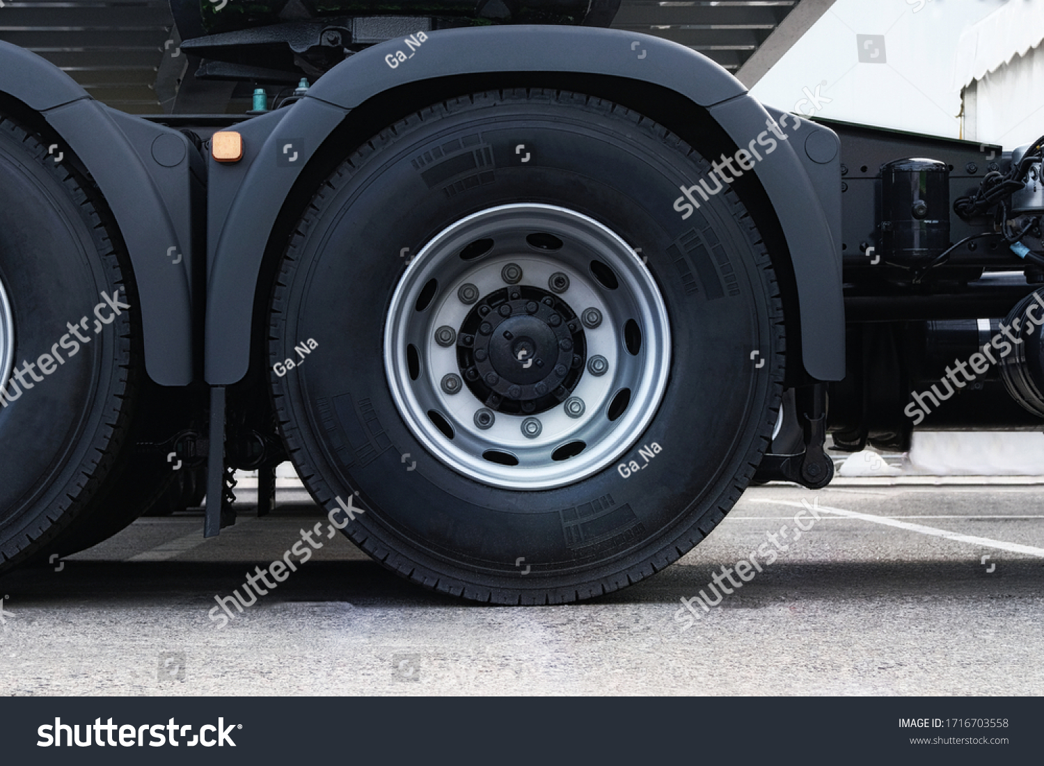 Truck tire, wheel of heavy duty semi truck, close up. Freight industry transport, wheels of modern truck.