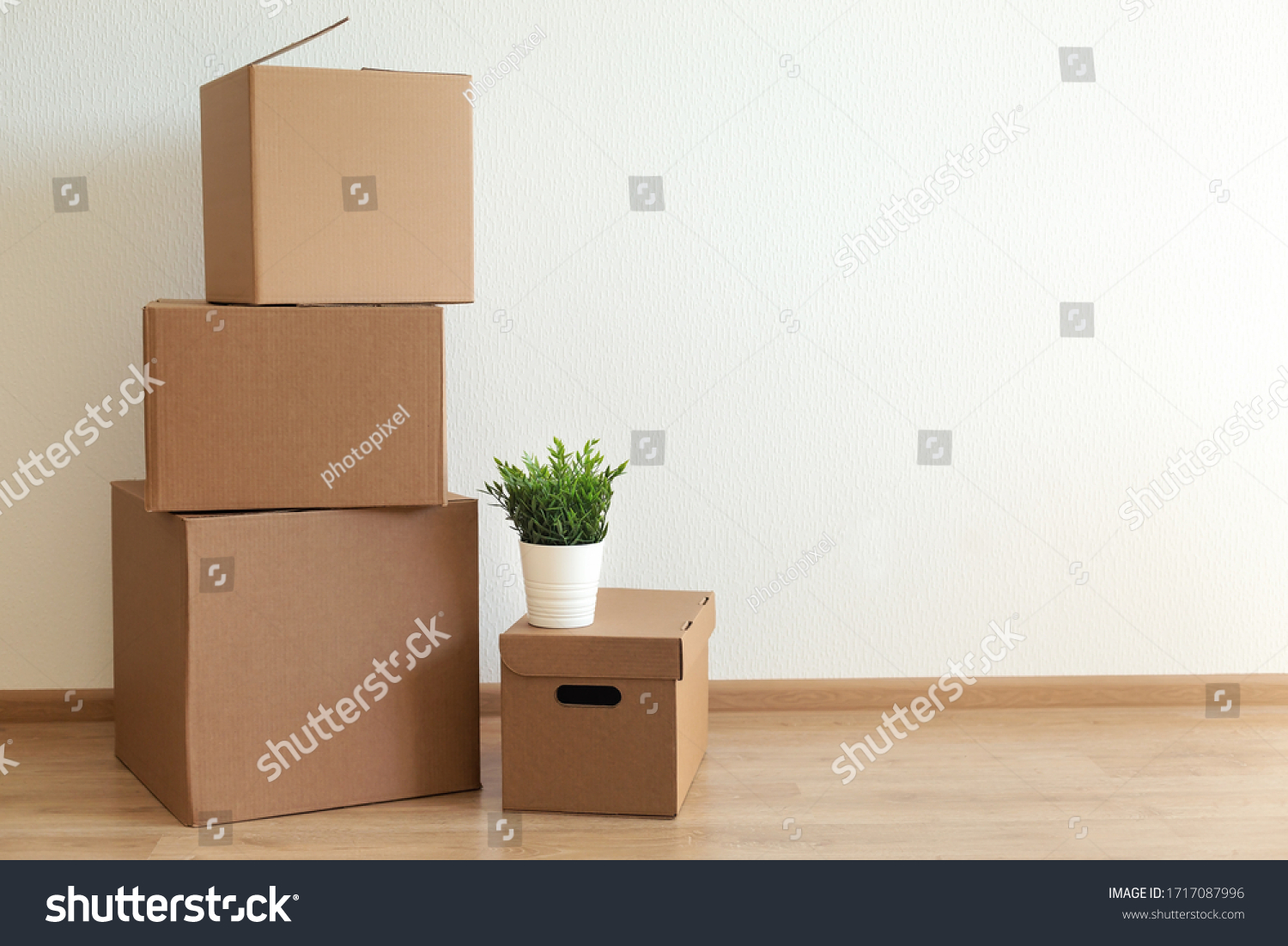Cardboard boxes in empty room, movement concept. No people #1717087996