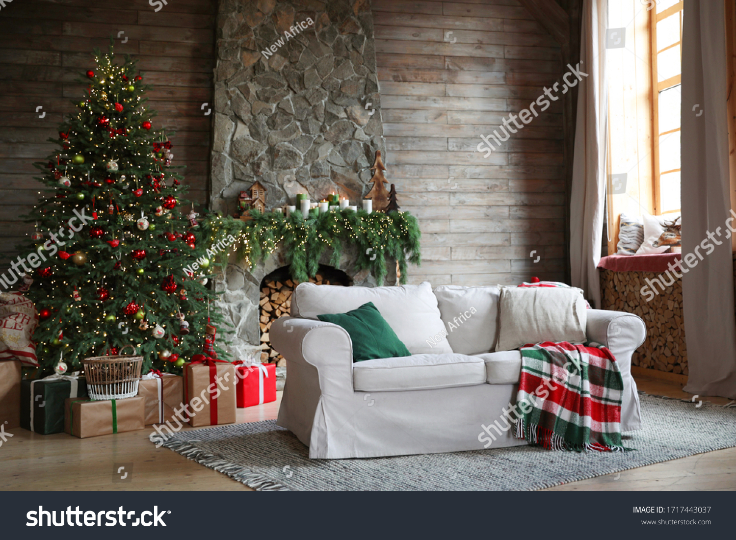 Festive interior with comfortable sofa and decorated Christmas tree #1717443037