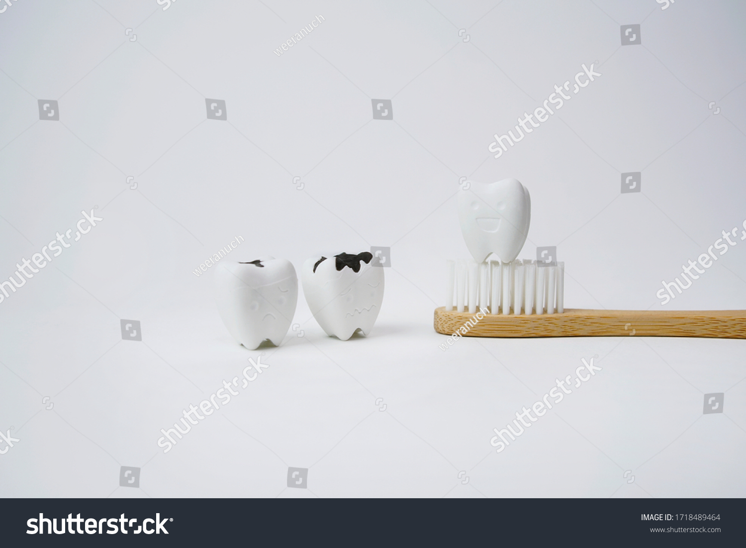 Healthy Tooth on Wooden Brown Toothbrush with Cavity and Decayed Tooth on White Background, If Brush Teeth, Teeth will Good Healthy #1718489464