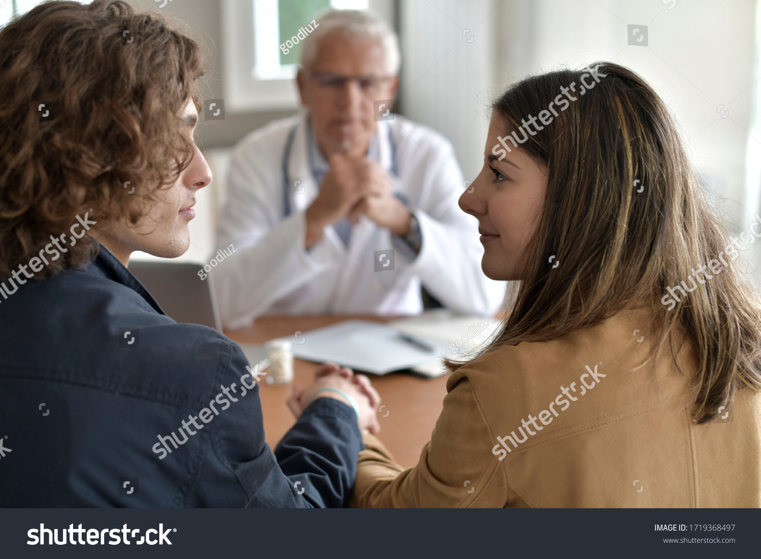 Young couple having an appointment at the doctor's office #1719368497