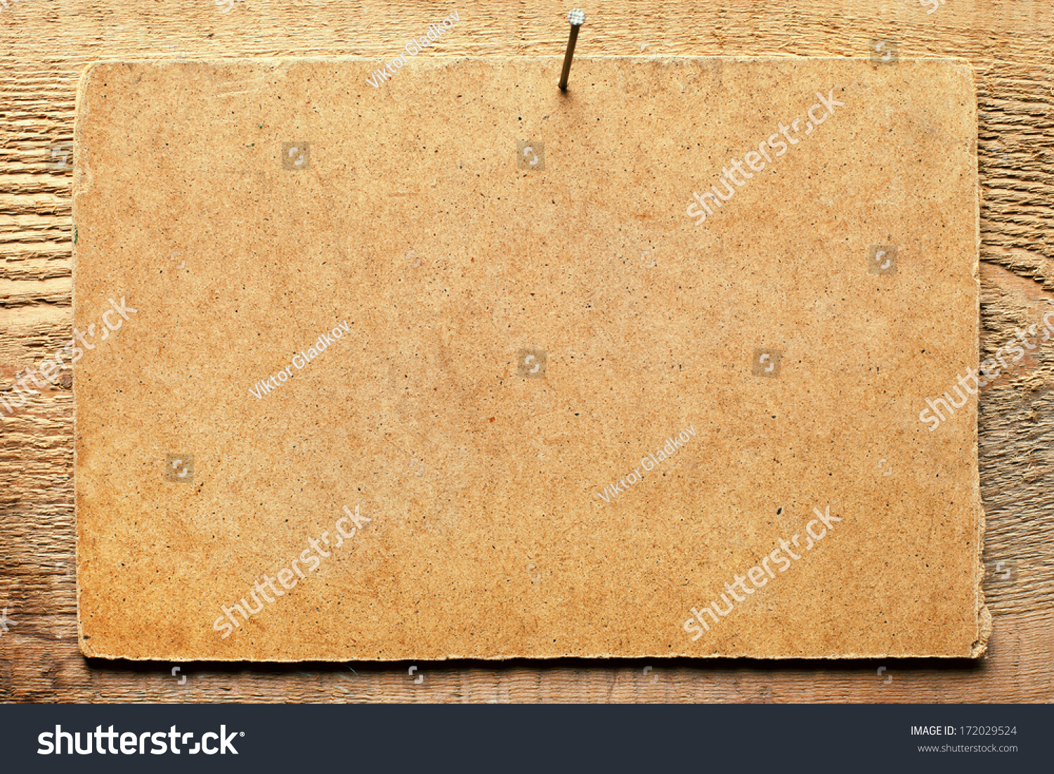 Cardboard nailed to wooden wall #172029524