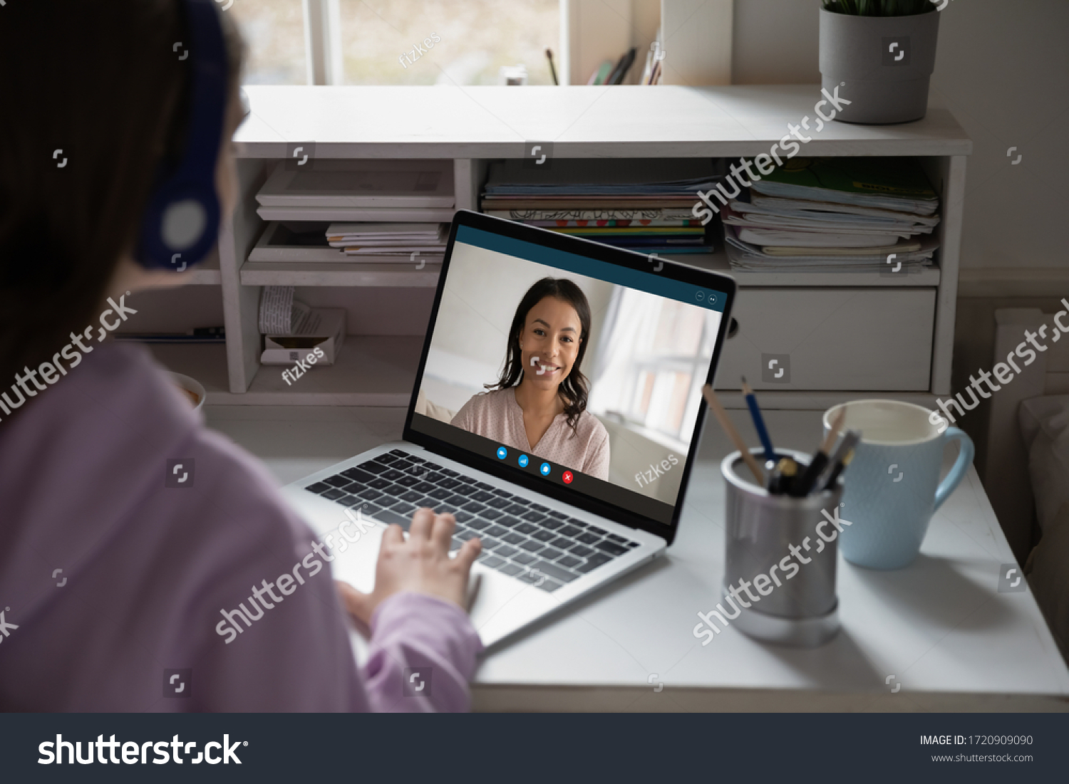Back view of young girl sit at desk at home talk have online video call lesson with teacher or tutor, teenage schoolgirl engaged in webcam conversation, study distant use web conference app on laptop #1720909090