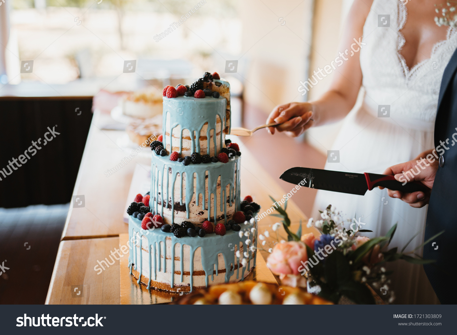 photo of a married couple cutting the cake #1721303809