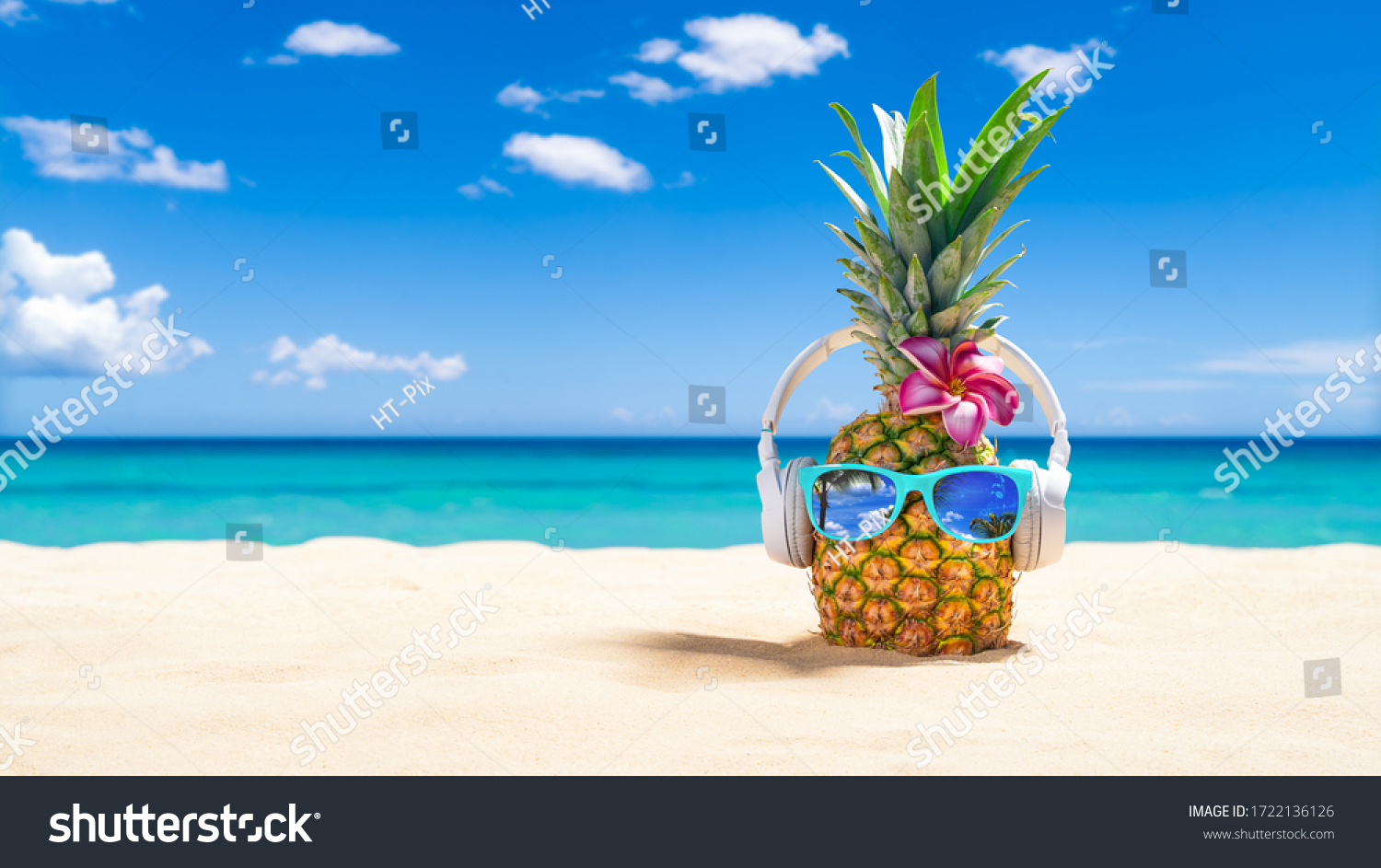 PinePineapple with sunglasses and headphones at tropical beach - Holiday Vacation Concept #1722136126
