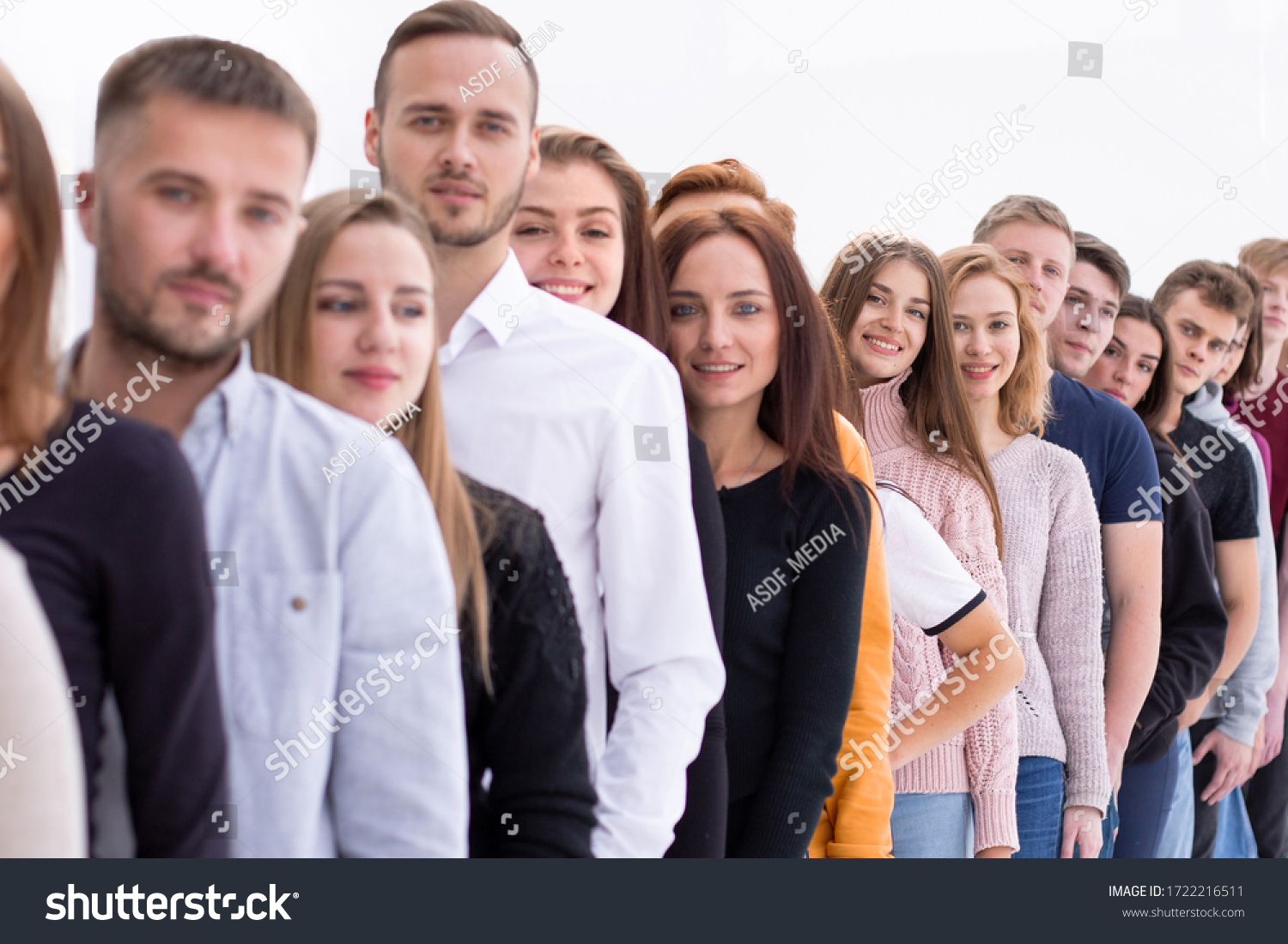 group of diverse young people standing in line #1722216511
