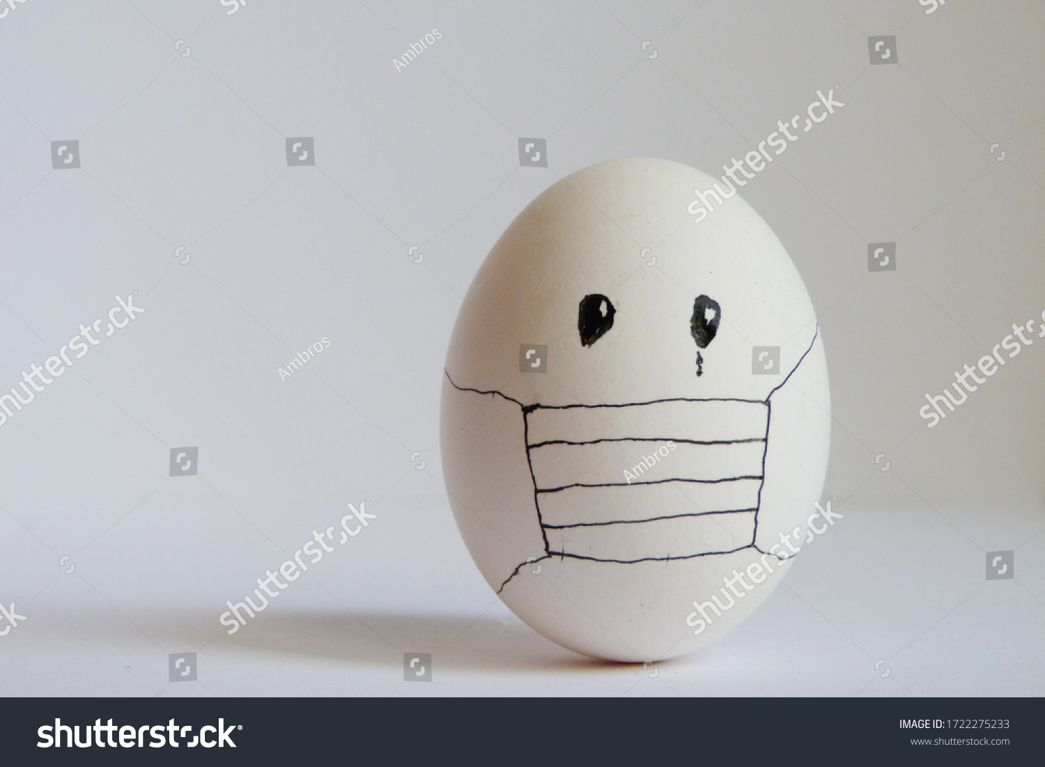 Eggs wearing medical mask for stop coronavirus and models of covid-19 virus on white background. Epidemic coronavirus COVID-19 concept. Place fo text #1722275233