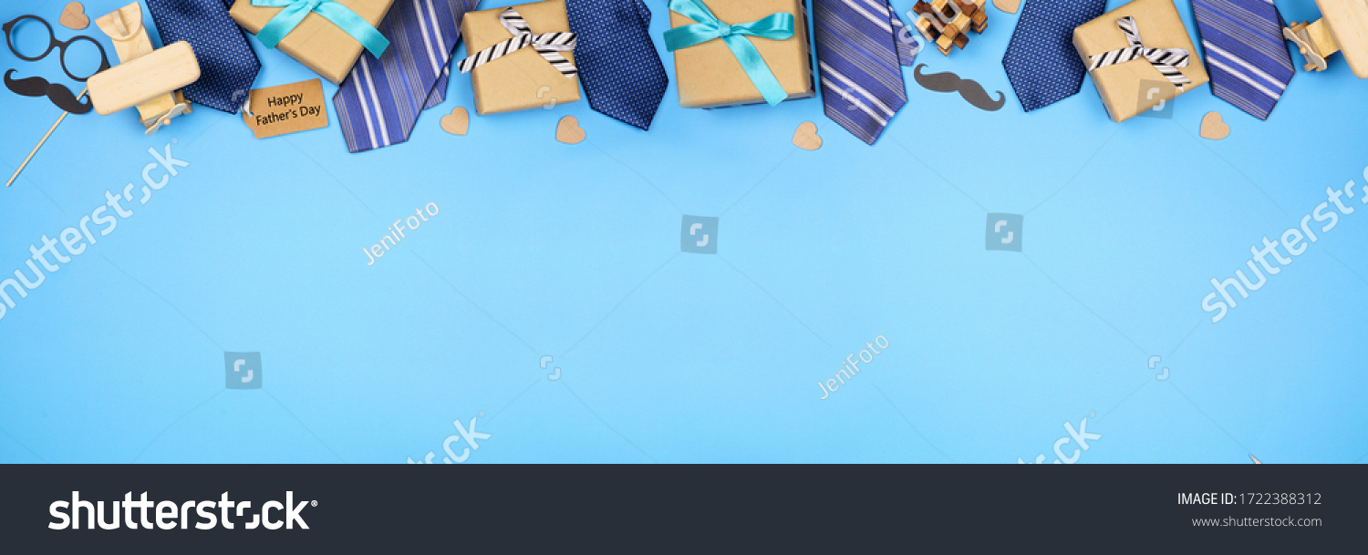 Happy Fathers Day gift tag with long border of ties, gifts and games on a blue banner background. Above view with copy space. #1722388312