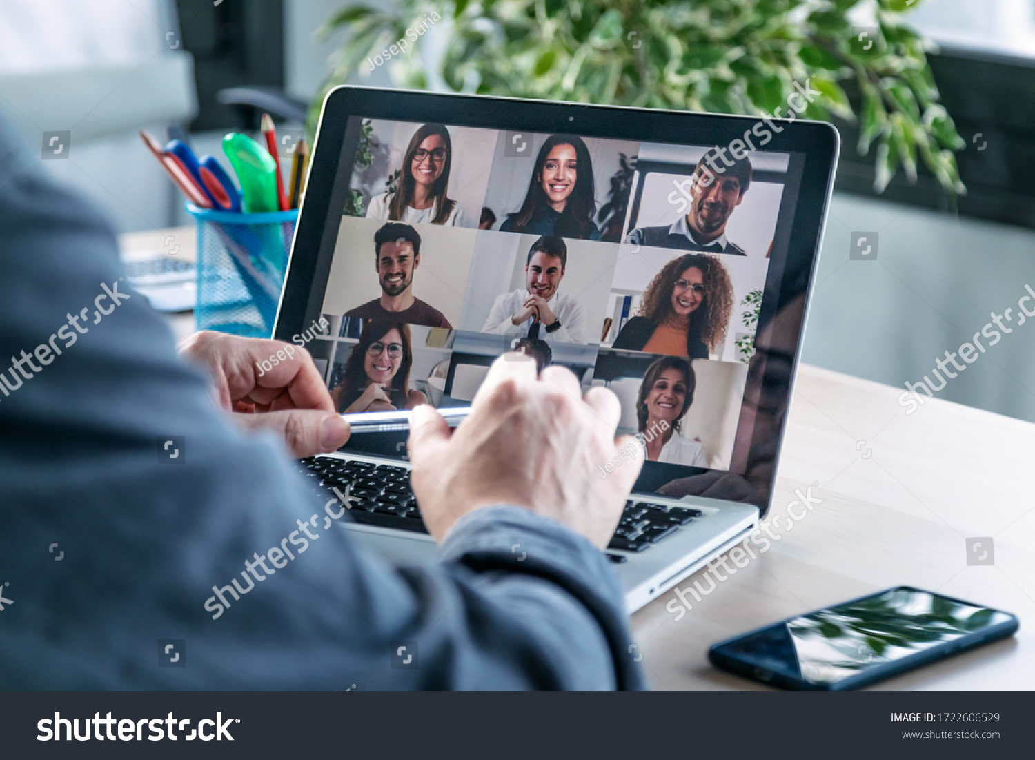 Back view of male employee speaking on video call with diverse colleagues on online briefing with laptop at home. #1722606529
