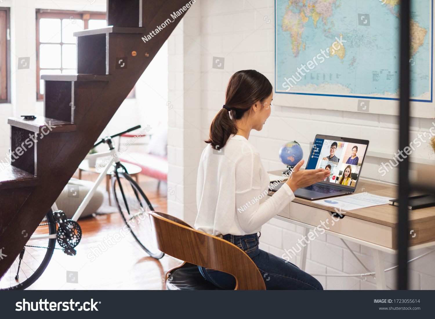 Young Asian businesswoman work at home and virtual video conference meeting with colleagues business people, online working, video call due to social distancing at home office #1723055614