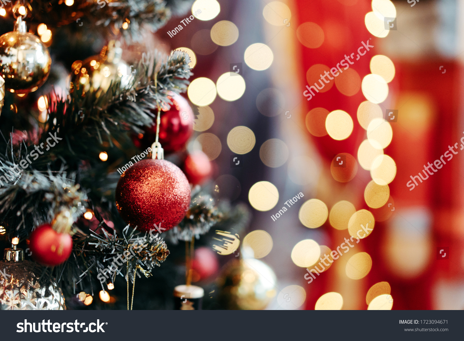 Close up of balls on christmas tree. Bokeh garlands in the background. New Year concept. #1723094671