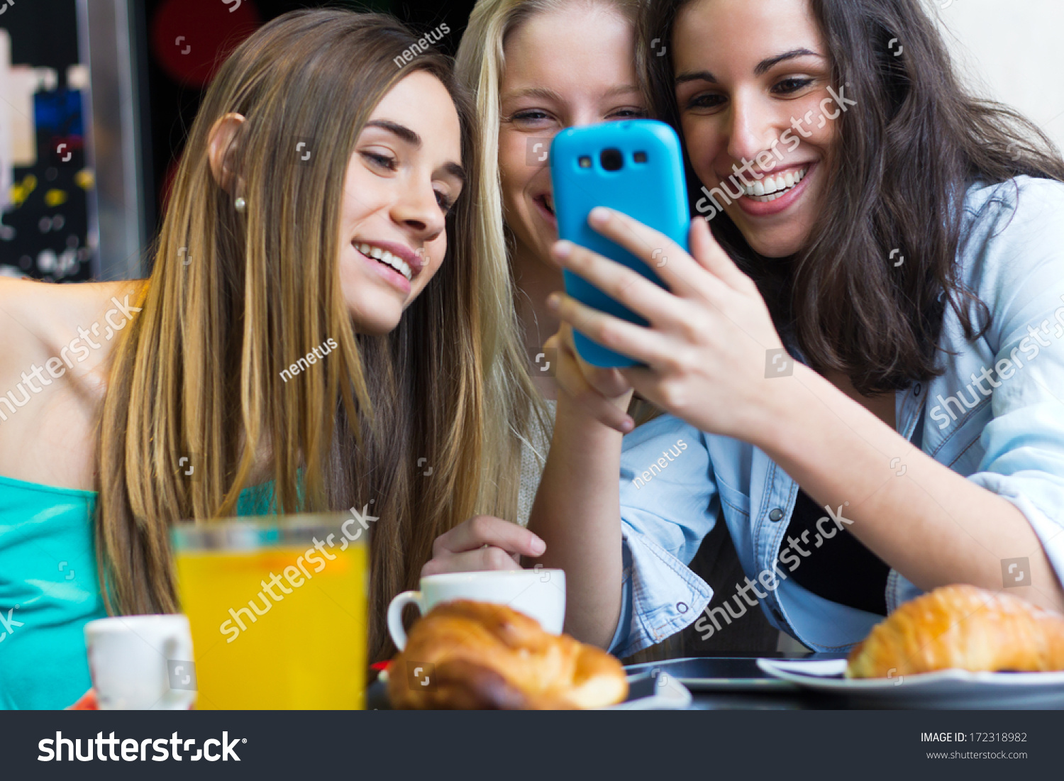 A group of friends having fun with smartphones #172318982