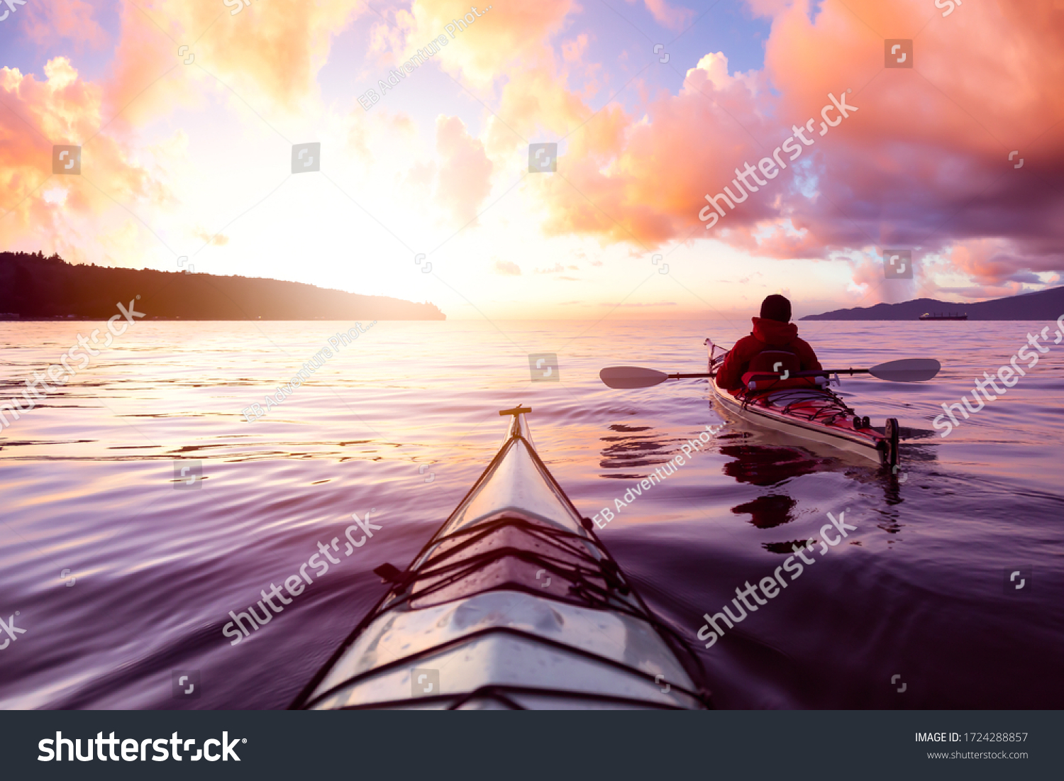 Adventurous Man Sea Kayaking in the Ocean during a colorful Sunset. Cloudy Sky Composite. Taken in Jericho, Vancouver, British Columbia, Canada. #1724288857
