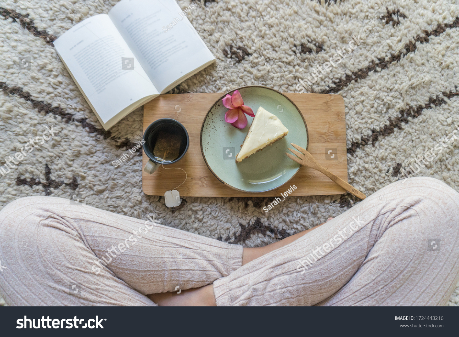 A girl enjoys a relaxing tea and cake while reading a book sitting on on a cosy Moroccan wool Beni Ourain rug. #1724443216