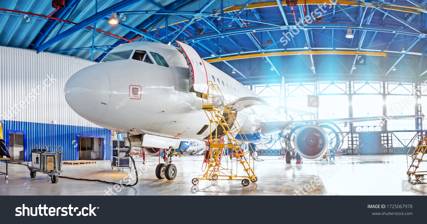 Panoramic view of aerospace hangar, civil aviation aircraft, repair and maintenance of mechanical parts in an industrial workshop #1725067978