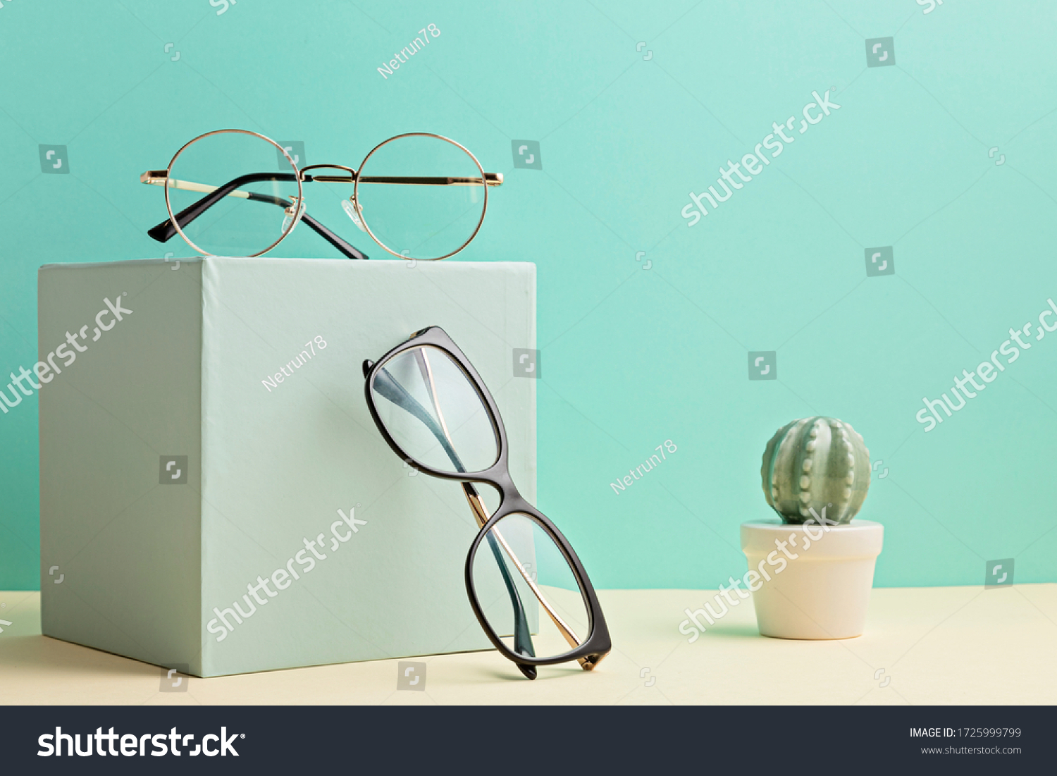 Stylish eyeglasses over pastel  background. Optical store, glasses selection, eye test, vision examination at optician, fashion accessories concept. Front view  #1725999799