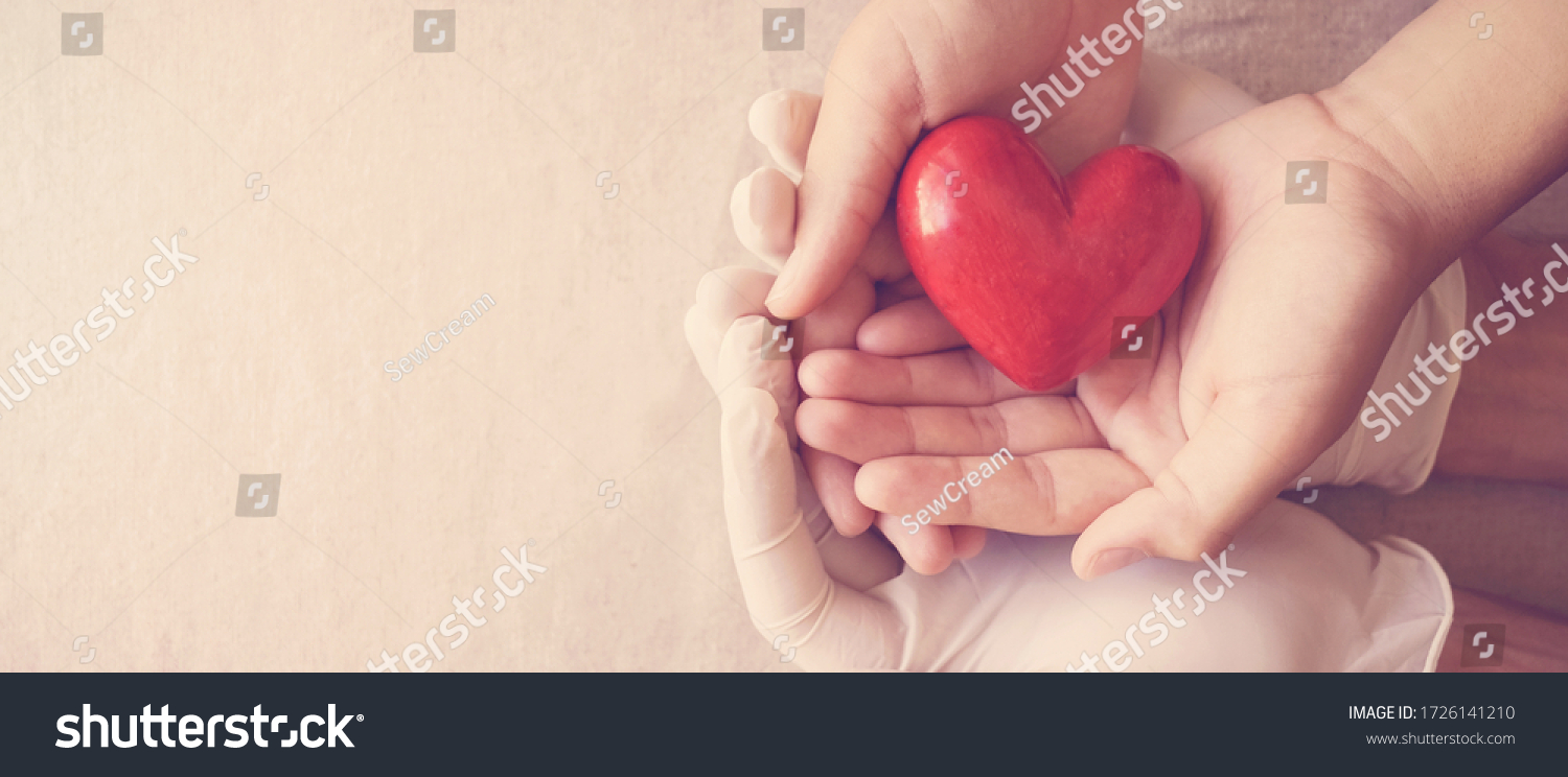 Doctor hands with medical gloves holding child hands and red heart, health insurance, organ donation, charity during covid-19 coronavirus pandemic, saving life, thank you and appreciation to doctor #1726141210