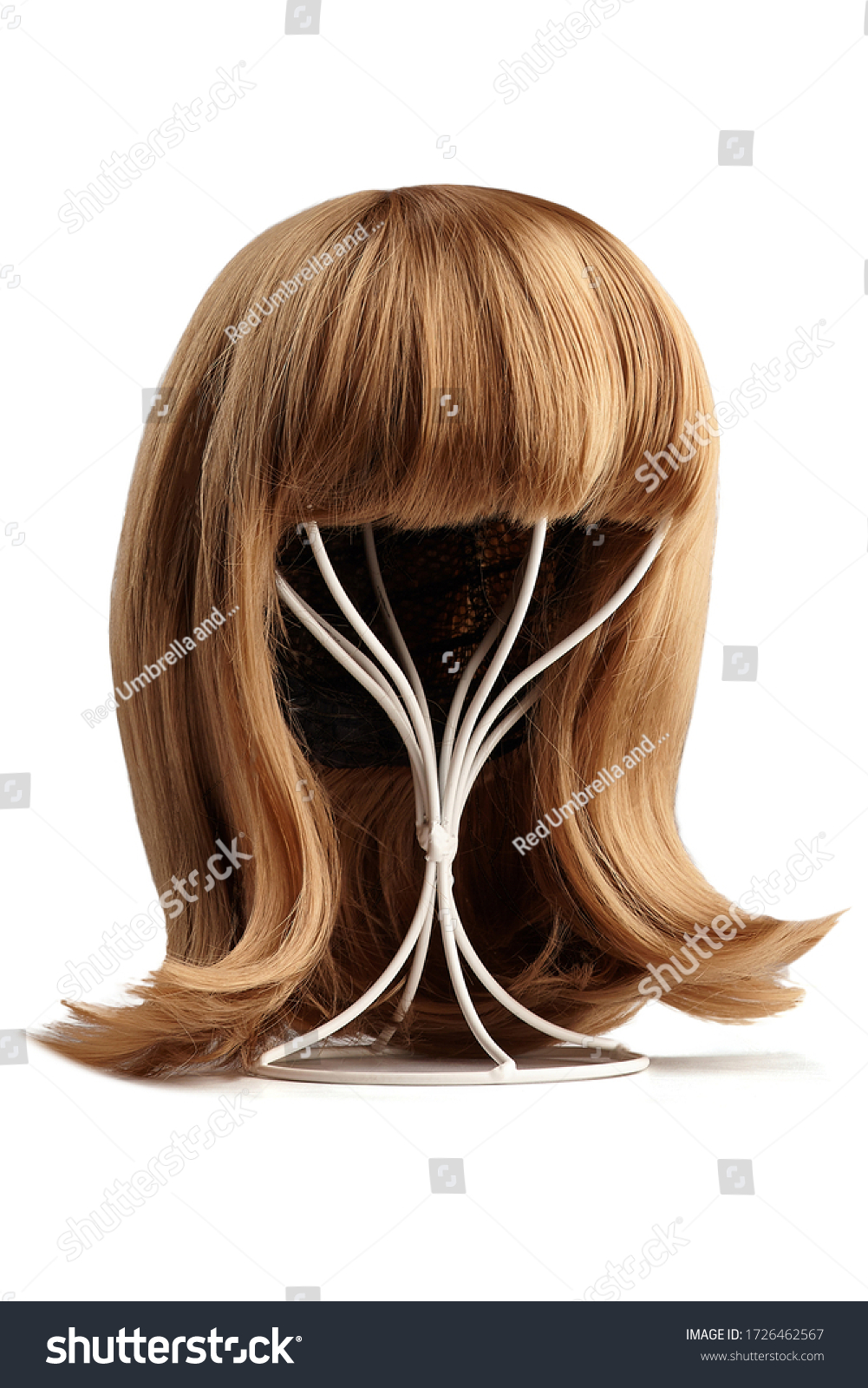 Subject shot of a natural looking blonde wig with bangs and twisted strands fixed on the white metal wig holder. The stand with the wig is isolated on a white background.   #1726462567