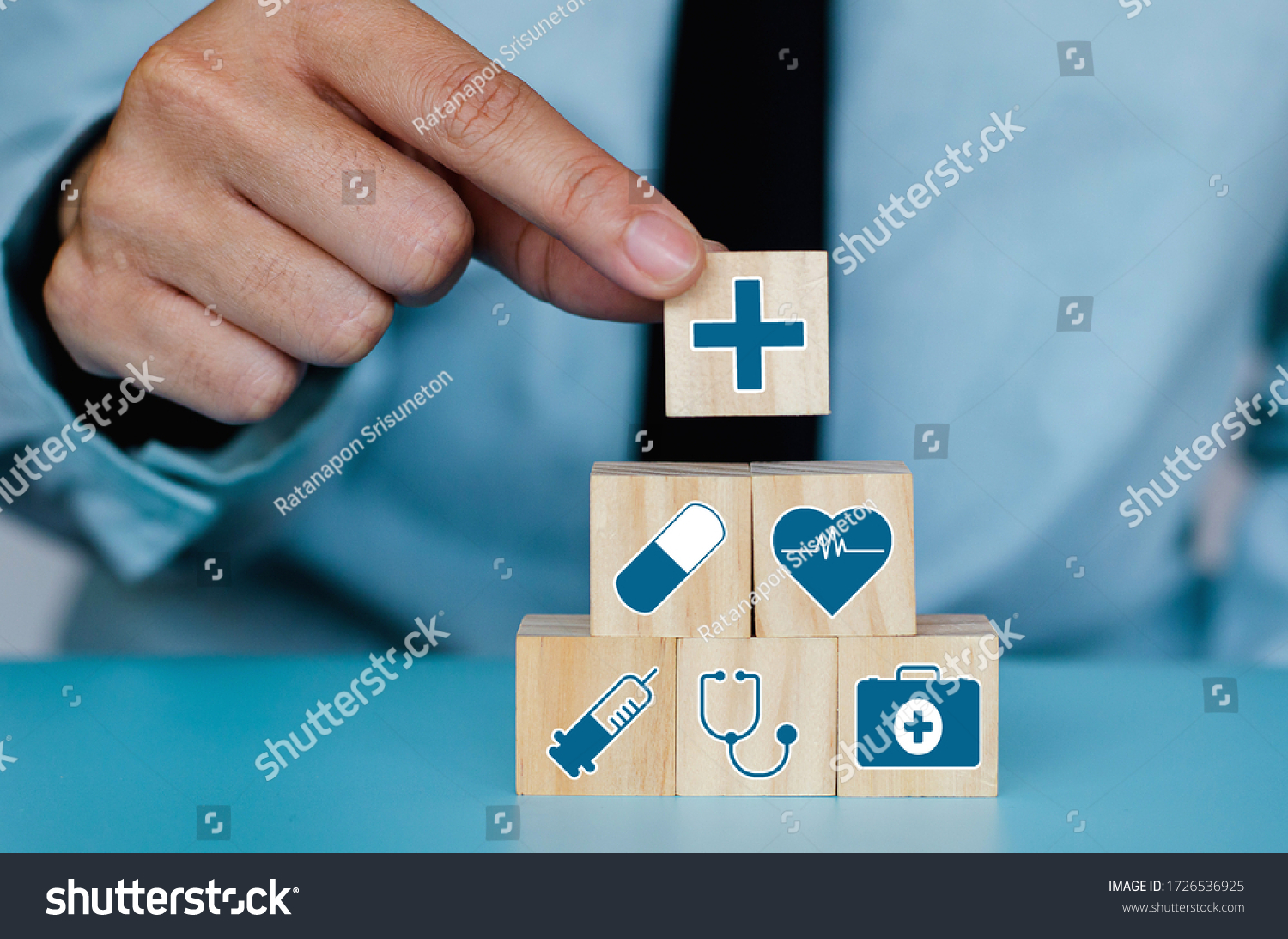Good Healthcare and Insurance concept.Business hand choose plus sign on wood cube block,Positive quantity,Take care and Safety. #1726536925