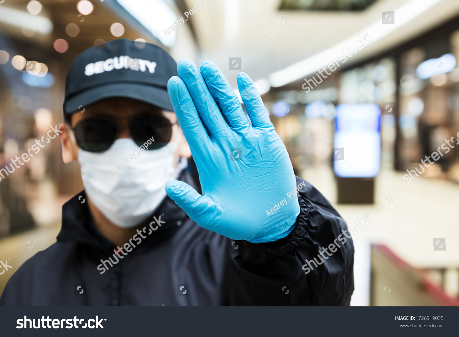Security Guard Making Stop Hand Gesture In Shopping Mall #1726919035