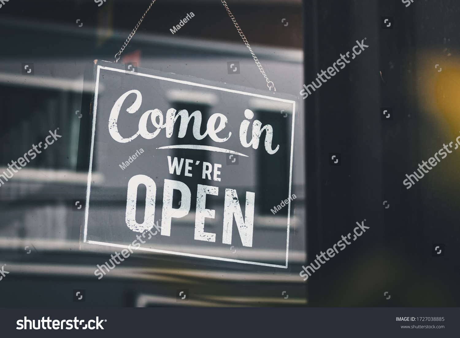 Come in we're open, vintage black retro sign in glass door storefront #1727038885