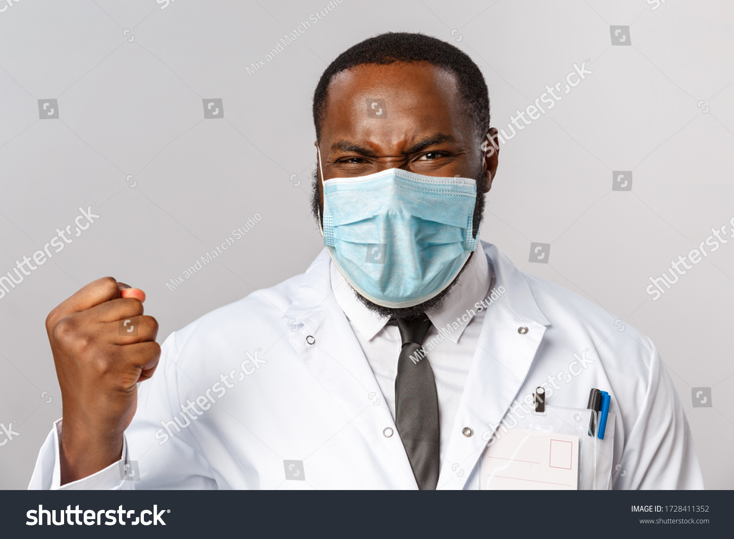 Healthcare, medicine and hospital treatment concept. Close-up portrait of triumphing, rejoicing african-american doctor finally fought disease got positive test results, fist pump and saying yes #1728411352